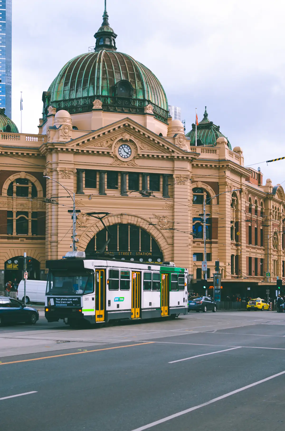 Flinders Street Station with a tram passing